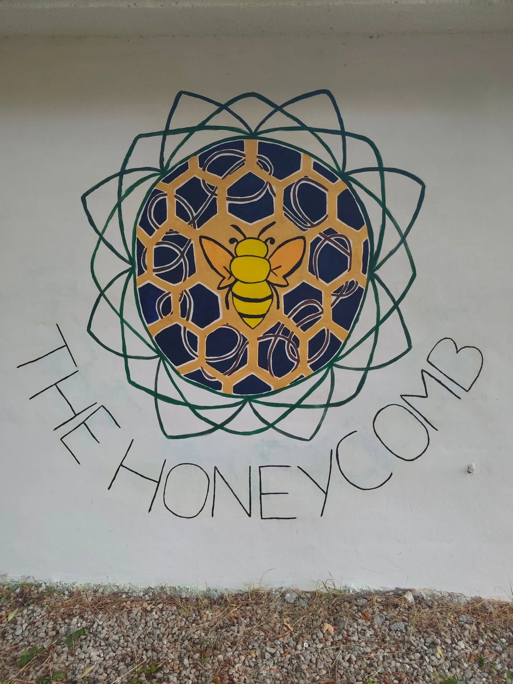 A large-scale hand-painted mural on a wall at Maiolo, made by a visiting artist