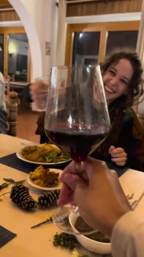 Volunteers sharing an evening meal and a toast
